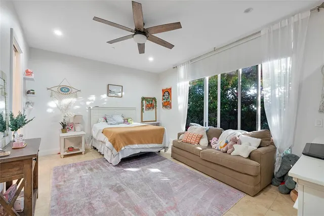 a bedroom with a bed couch and window