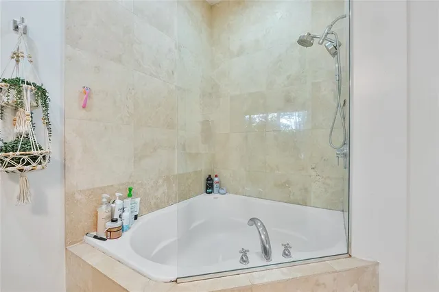 a white bath tub sitting next to a white sink
