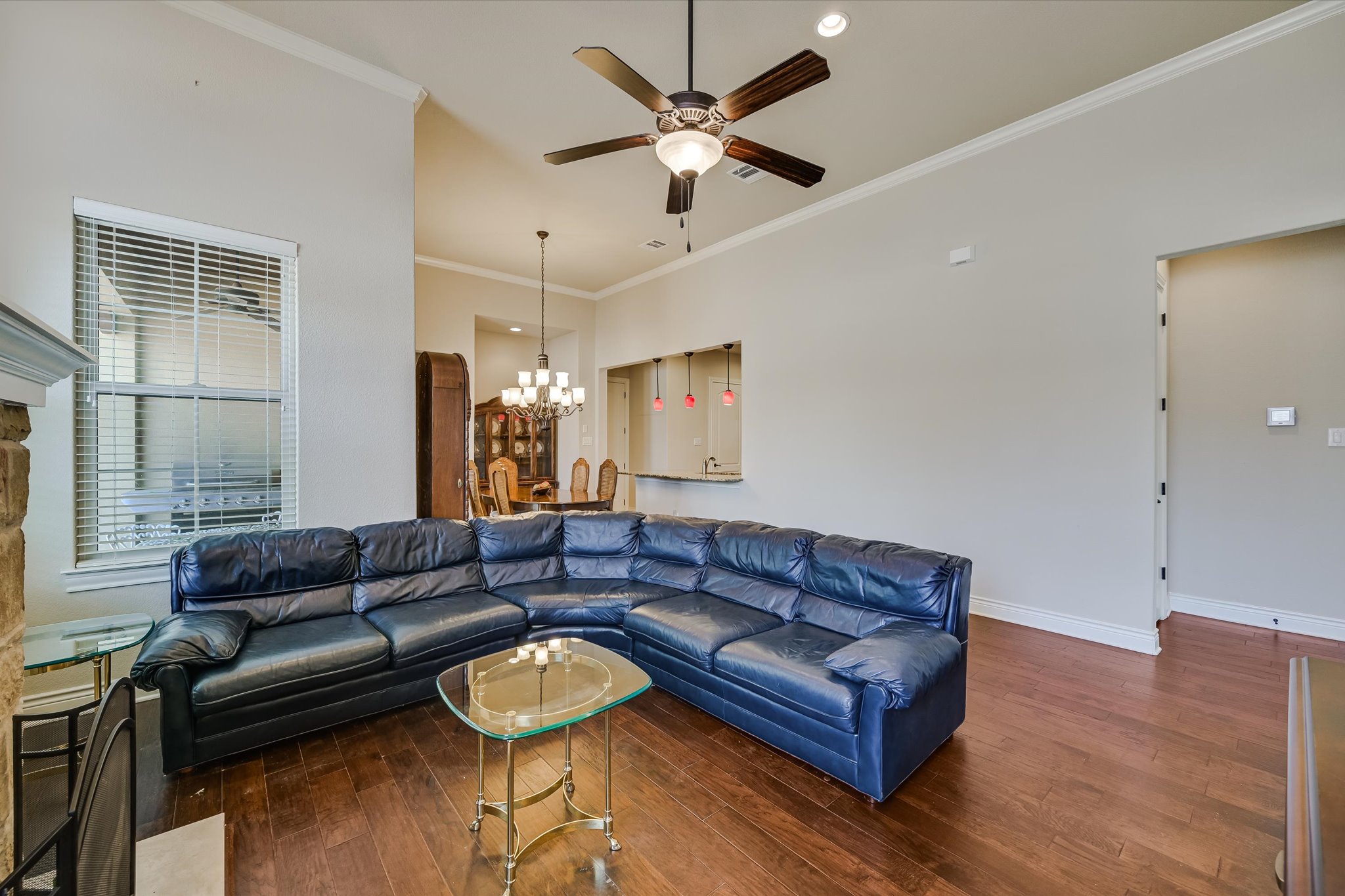 103 Rivalto Circle, Unit 1 Lakeway, TX 78734 - Photo 4 of 34 Living room with high ceilings, hardwood floors and a fireplace