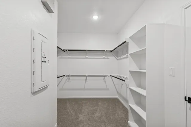 a view of walk in closet with empty racks