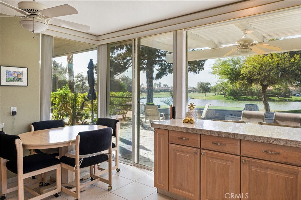 37 Oak Tree Drive Rancho Mirage, CA 92270 - Photo 12 of 54 a dining room with wooden floor a glass table and chairs