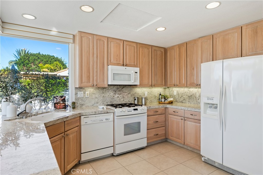 37 Oak Tree Drive Rancho Mirage, CA 92270 - Photo 17 of 54 a kitchen with a white stove top oven and refrigerator