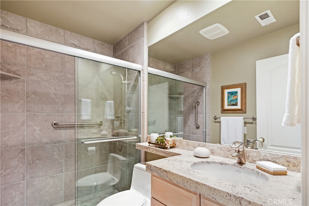 37 Oak Tree Drive Rancho Mirage, CA 92270 - Photo 21 of 54 a bathroom with a granite countertop sink a toilet a mirror and shower