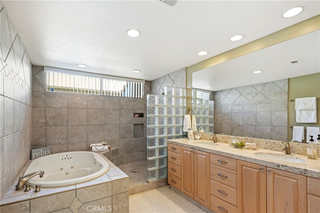 37 Oak Tree Drive Rancho Mirage, CA 92270 - Photo 24 of 54 a bathroom with a tub sink double vanity and mirror