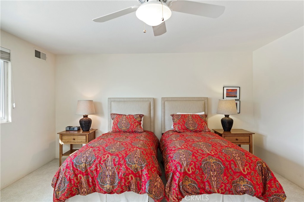 37 Oak Tree Drive Rancho Mirage, CA 92270 - Photo 26 of 54 a bedroom with two beds and a chandelier