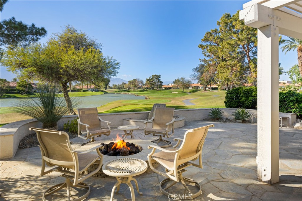 37 Oak Tree Drive Rancho Mirage, CA 92270 - Photo 3 of 54 a view of a patio with lake view and a potted plant