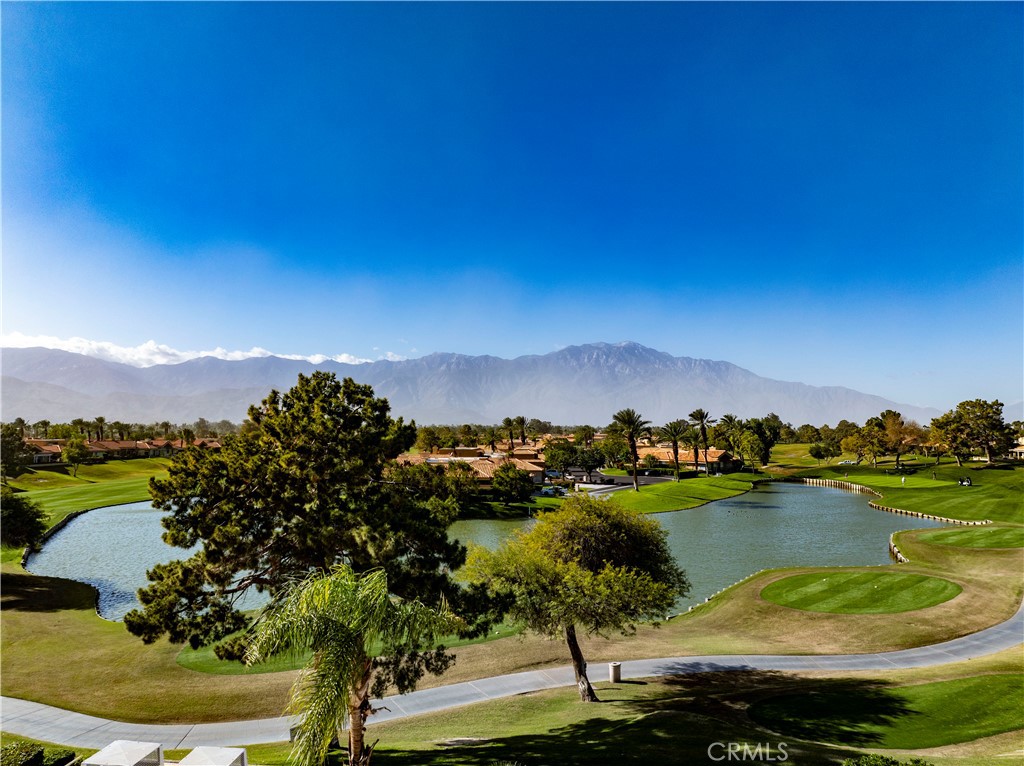 37 Oak Tree Drive Rancho Mirage, CA 92270 - Photo 41 of 54 a view of a lake with houses in the back