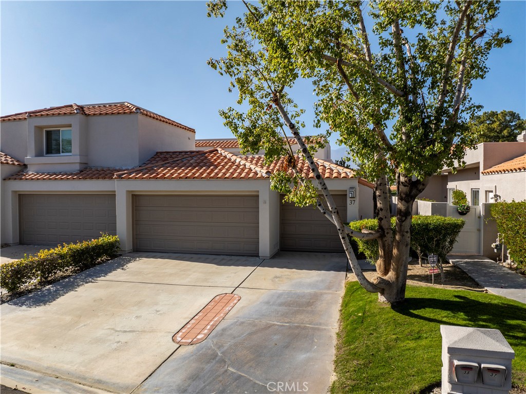 37 Oak Tree Drive Rancho Mirage, CA 92270 - Photo 50 of 54 a front view of a house with garden