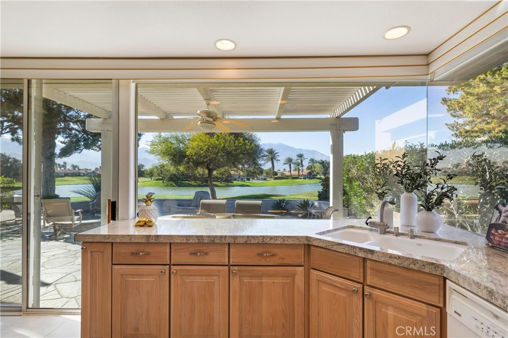 37 Oak Tree Drive Rancho Mirage, CA 92270 - Photo 5 of 54 a kitchen with kitchen island a large window in it