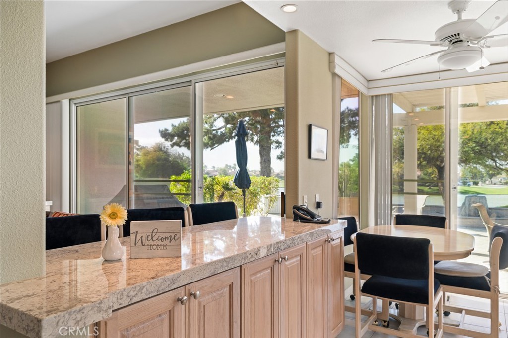37 Oak Tree Drive Rancho Mirage, CA 92270 - Photo 10 of 54 a kitchen with a large window and a table