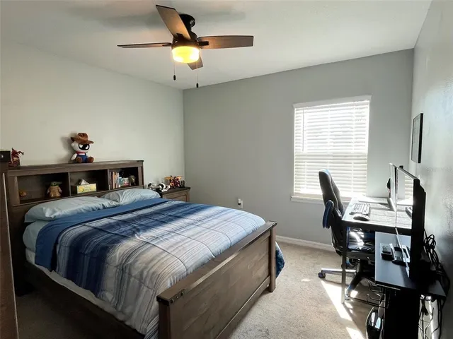 a bedroom with a bed and a desk