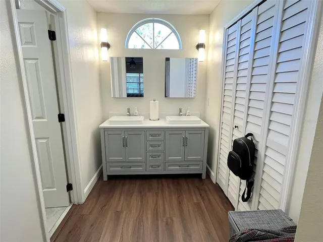 a bathroom with a double vanity sink and mirror