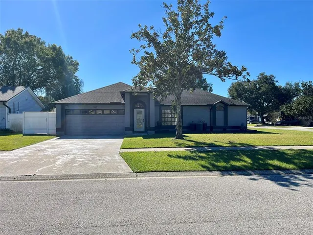 a front view of a house with a yard and a garden