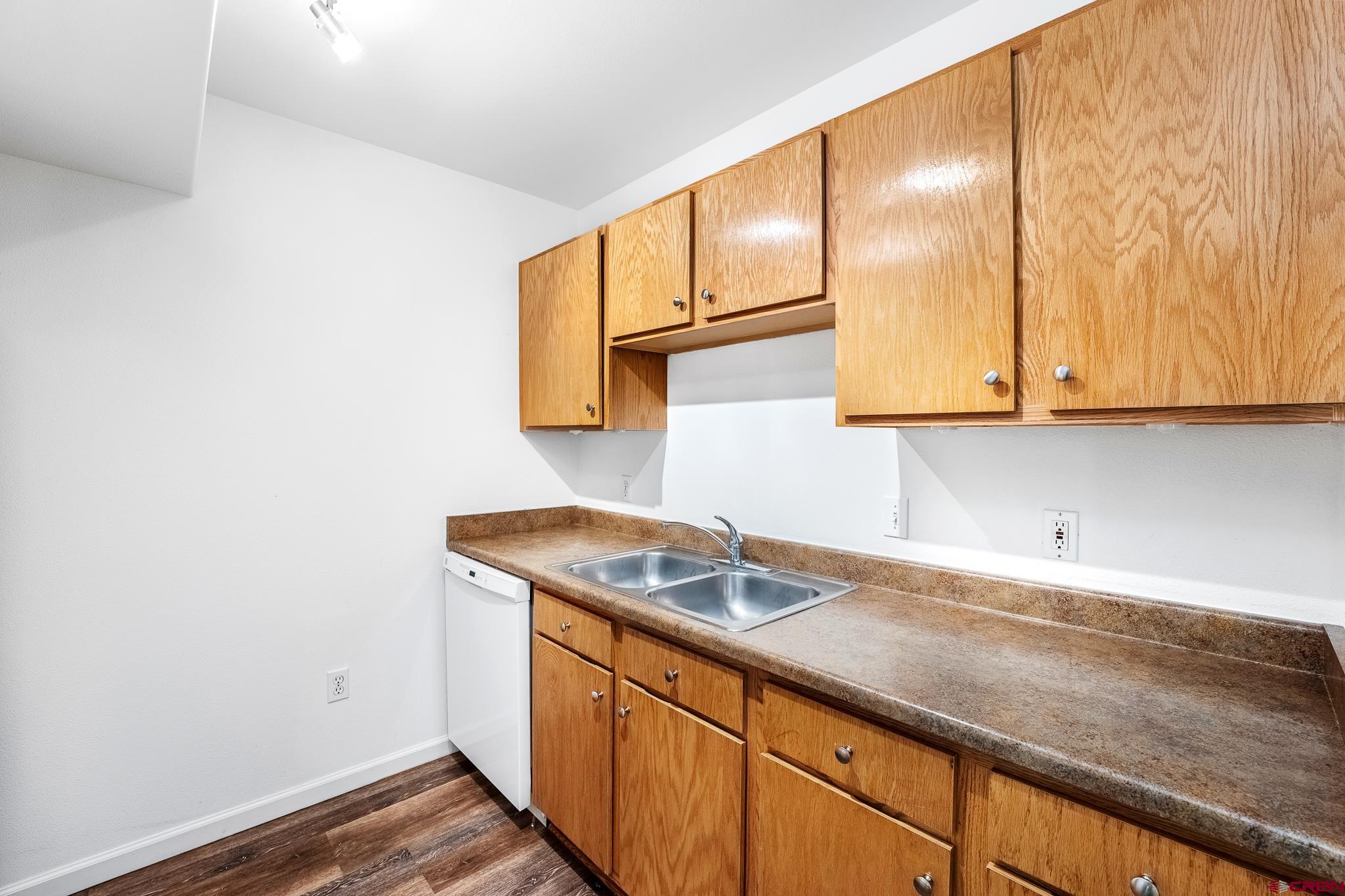 1100 Goeglein Gulch Road, Unit 164 Durango, CO 81301 - Photo 8 of 31 a kitchen with a sink and cabinets