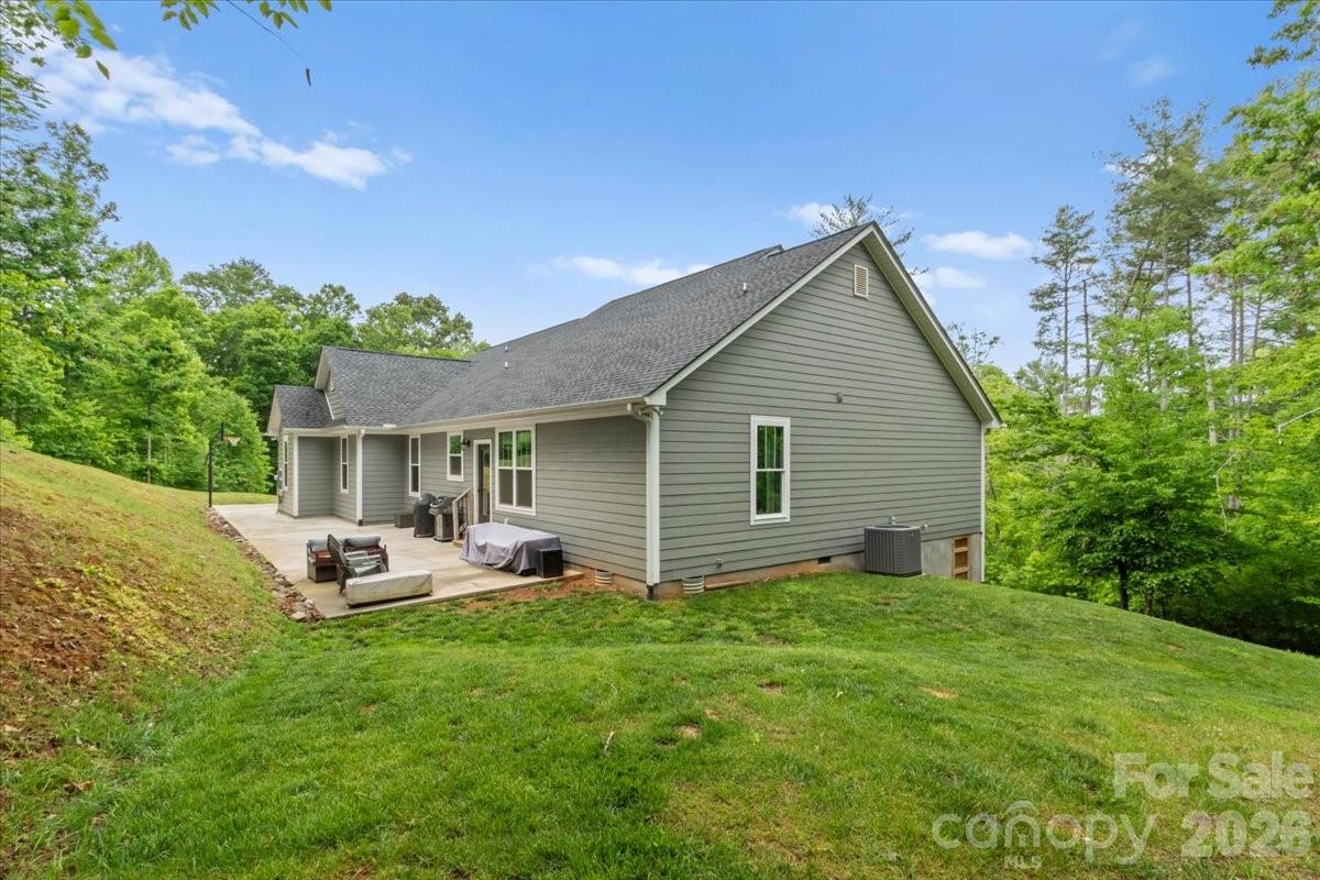 36 Cherry Ridge Lane Weaverville, NC 28787 - Photo 33 of 37 a backyard of a house with garden and outdoor seating