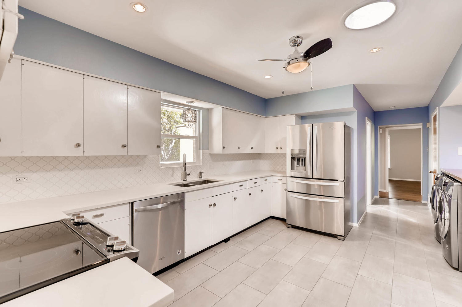 446 Pike Road San Antonio, TX 78209 - Photo 9 of 28 A sleek and modern kitchen boasts stainless steel appliances, pristine white cabinetry, and abundant natural light.