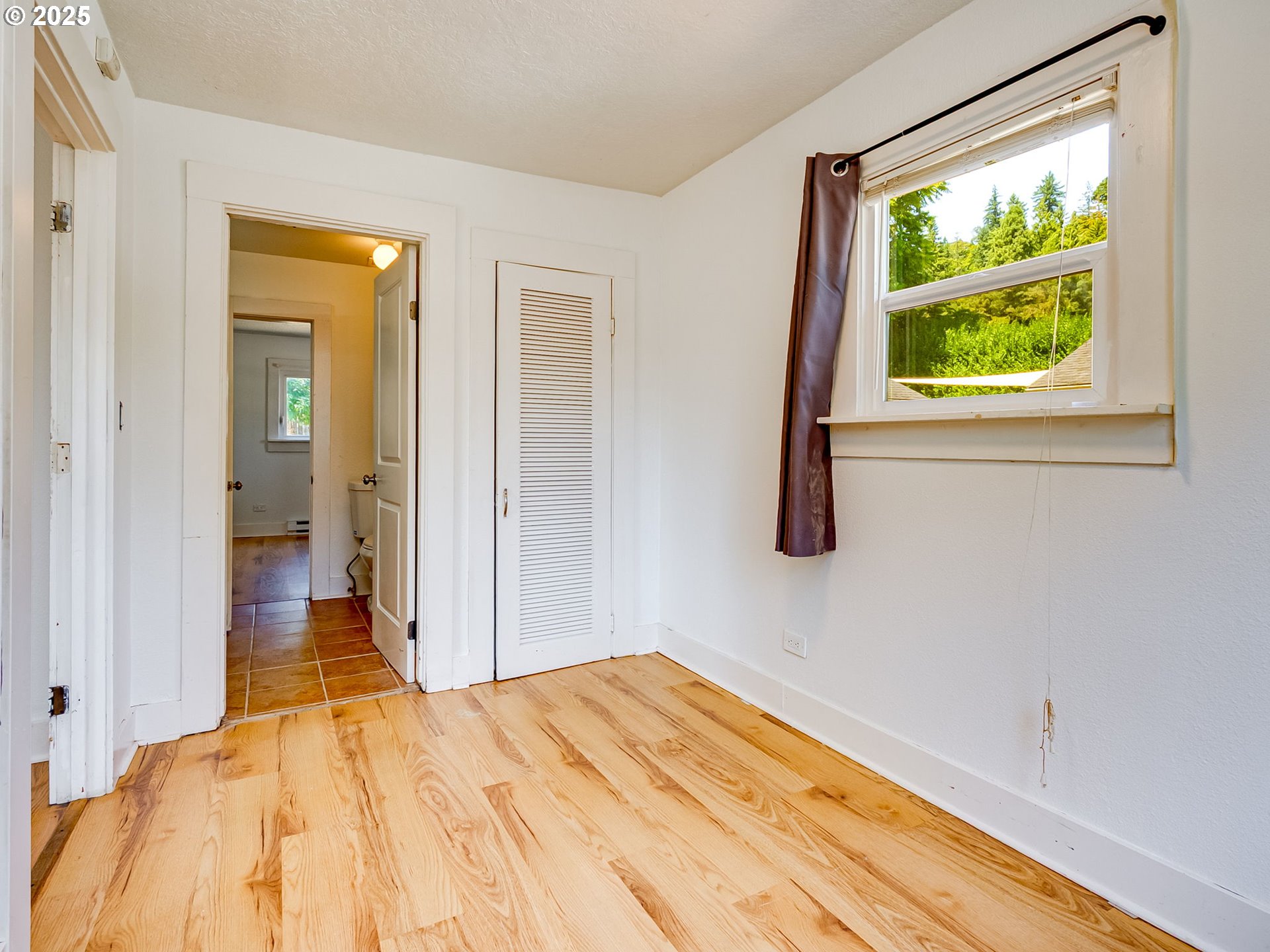907 Northwest Greeley Street Camas, WA 98607 - Photo 18 of 31 a view of a bedroom with wooden floor and a window