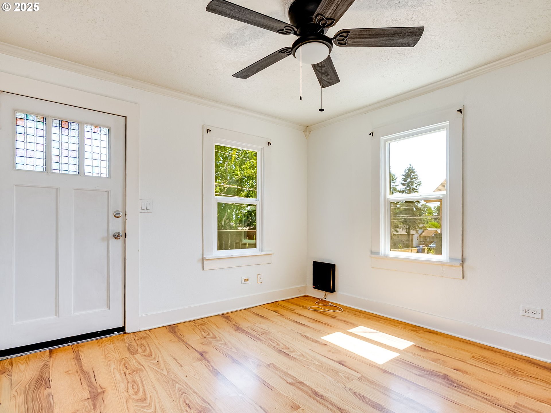 907 Northwest Greeley Street Camas, WA 98607 - Photo 6 of 31 a view of an empty room with wooden floor and a window