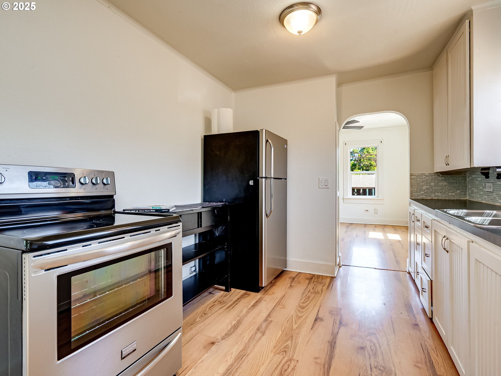 907 Northwest Greeley Street Camas, WA 98607 - Photo 10 of 31 a kitchen with granite countertop wooden floors and stainless steel appliances