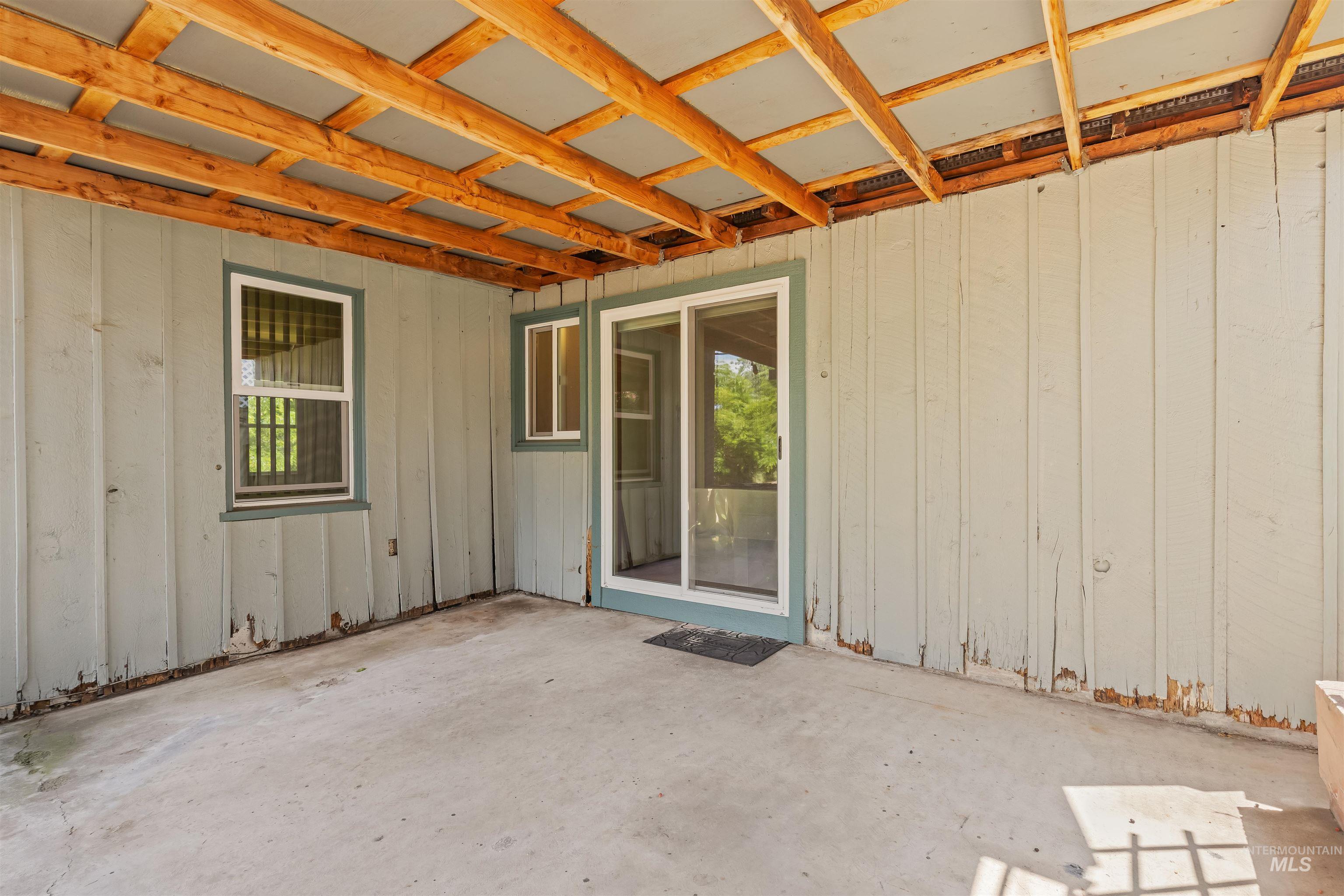 1663 9th Avenue Lewiston, ID 83501 - Photo 32 of 36 Covered patio area with a concrete floor, exposed wood ceiling beams, and a sliding glass door