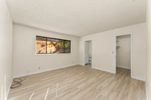 a kitchen with a table chairs refrigerator and cabinets