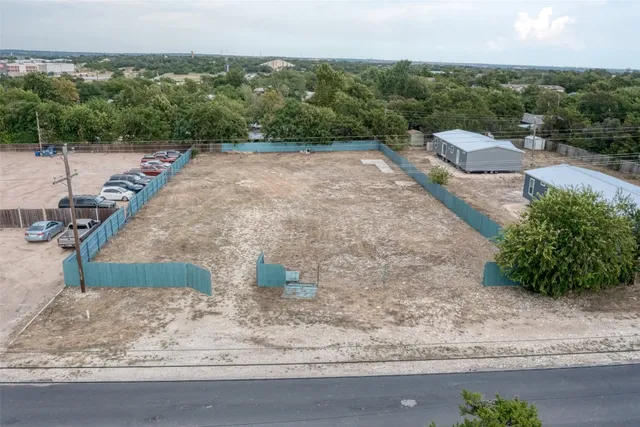 a view of a yard and car parked