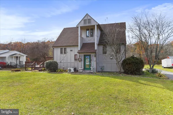 a front view of house with yard and green space