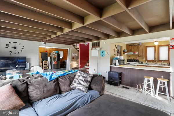 a open kitchen with stainless steel appliances a stove a refrigerator a sink and a cabinets