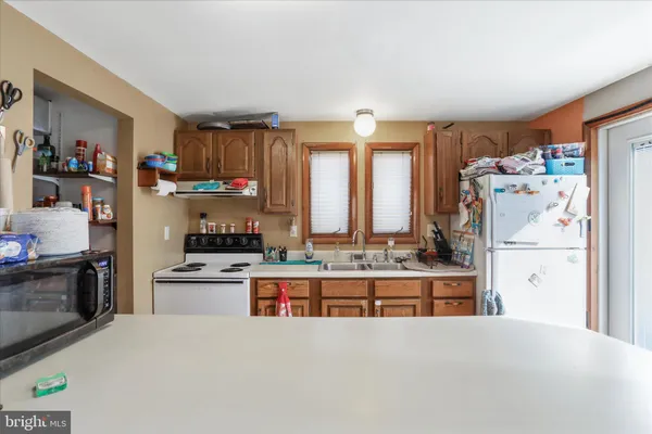 a kitchen with stainless steel appliances a sink a stove and a refrigerator