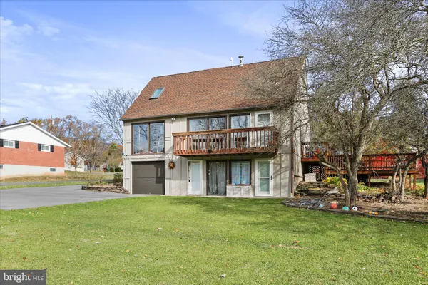 a view of a house with a yard and sitting area