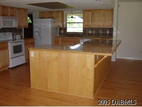 1969 Taylor Road Port Orange, FL 32128 - Photo 5 of 7 a kitchen with refrigerator and window