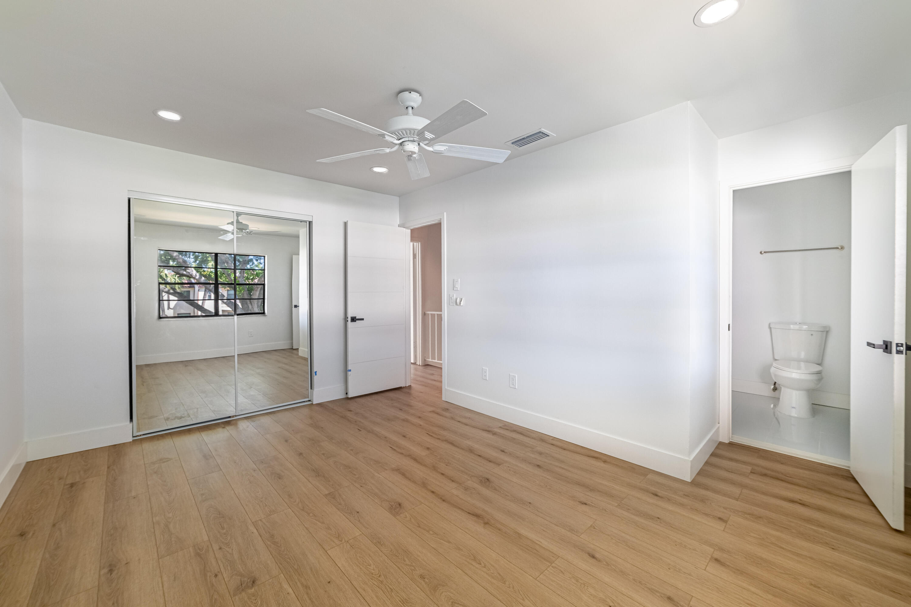 21864 Arriba Real, Unit 3E Boca Raton, FL 33433 - Photo 18 of 32 wooden floor in an empty room with a window