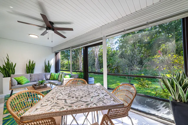 a view of a patio with a table chairs and a swimming pool