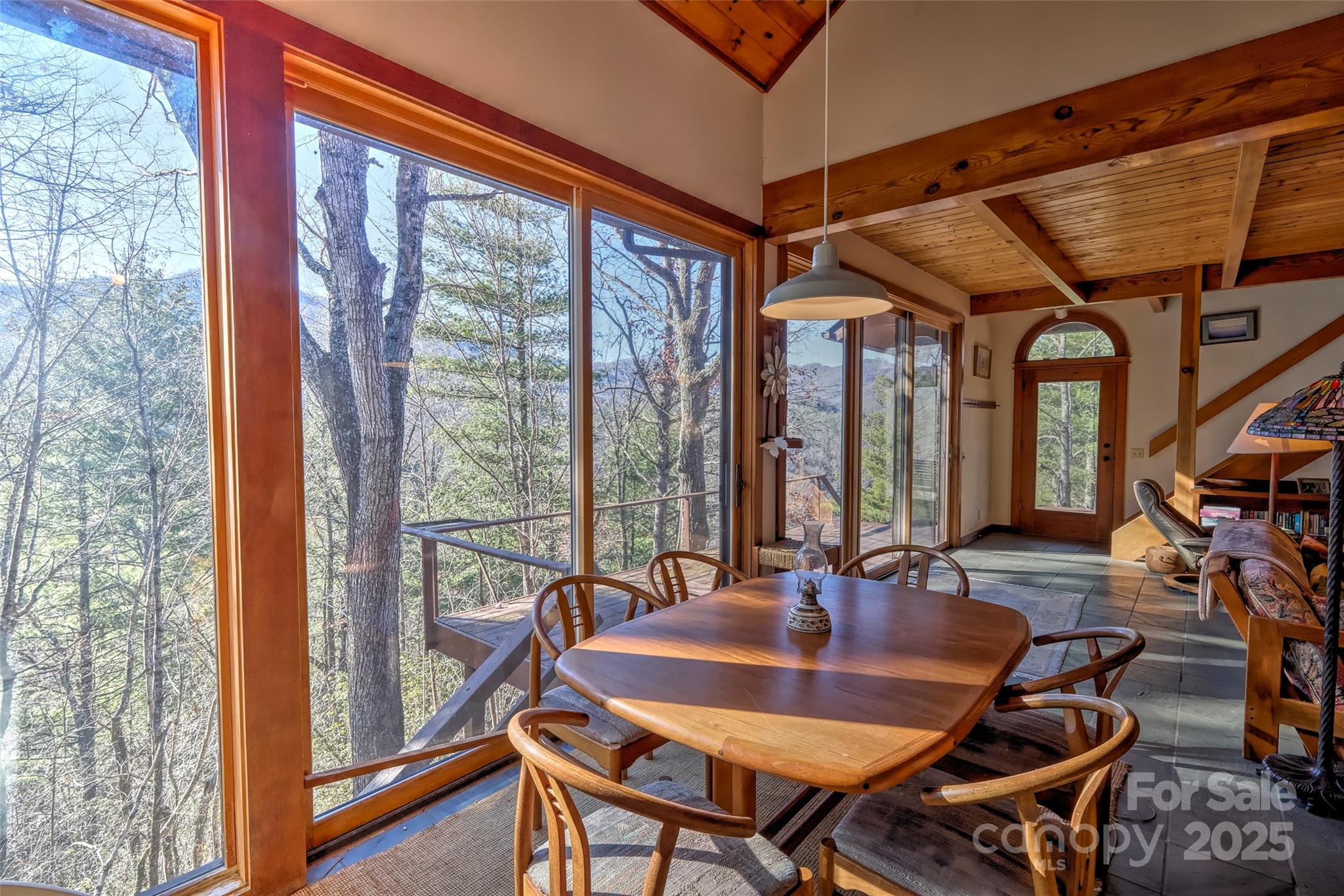 565 Silver Ridge Road Bryson City, NC 28713 - Photo 2 of 45 a dining room with furniture a chandelier and wooden floor