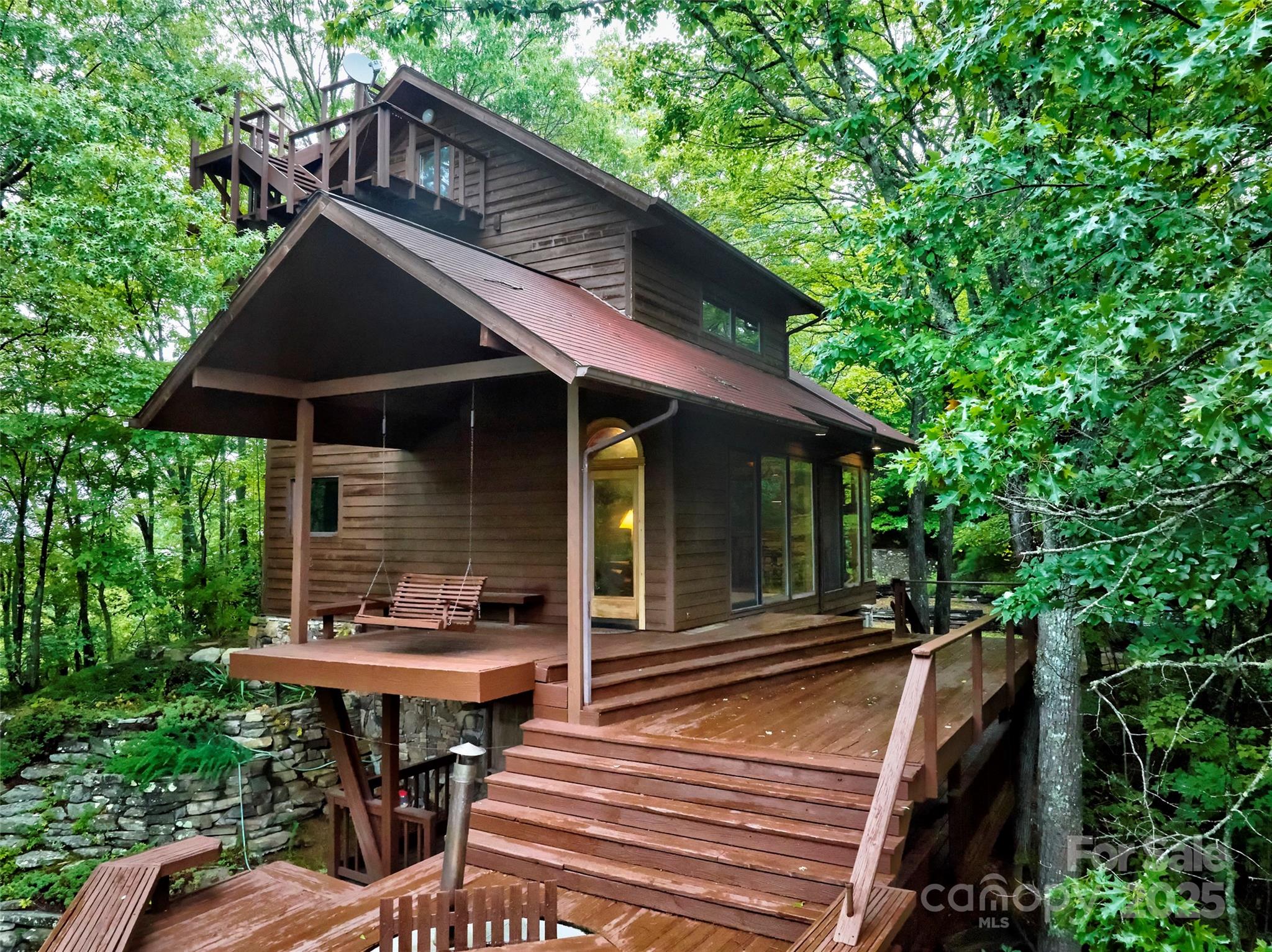 565 Silver Ridge Road Bryson City, NC 28713 - Photo 36 of 45 a backyard of a house with table and chairs under an umbrella