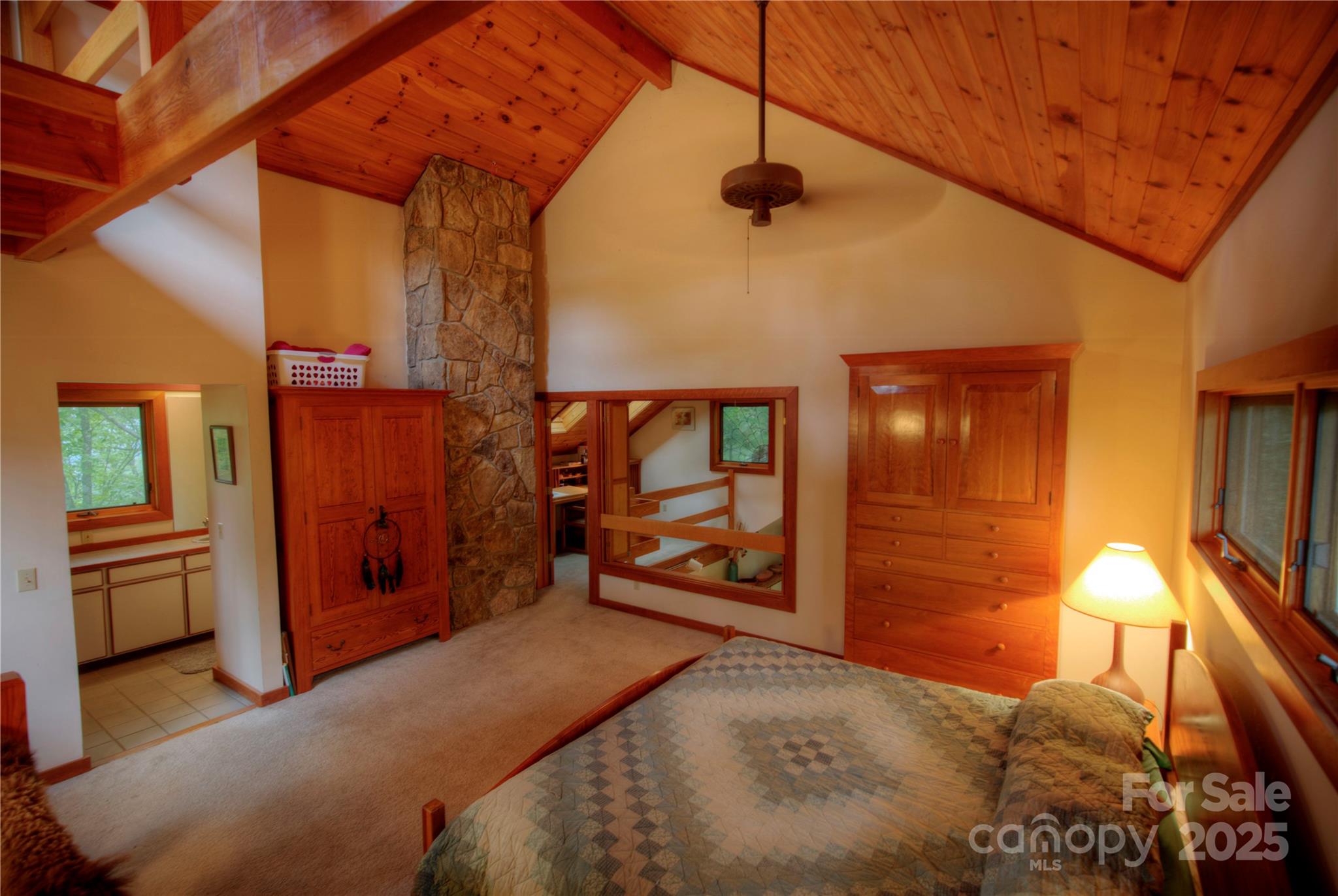 565 Silver Ridge Road Bryson City, NC 28713 - Photo 39 of 45 a bedroom with a bed and wooden floor
