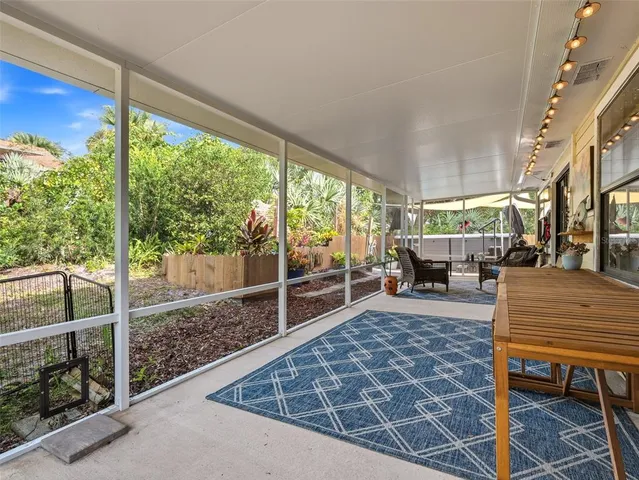 a living room with furniture a large window and a rug