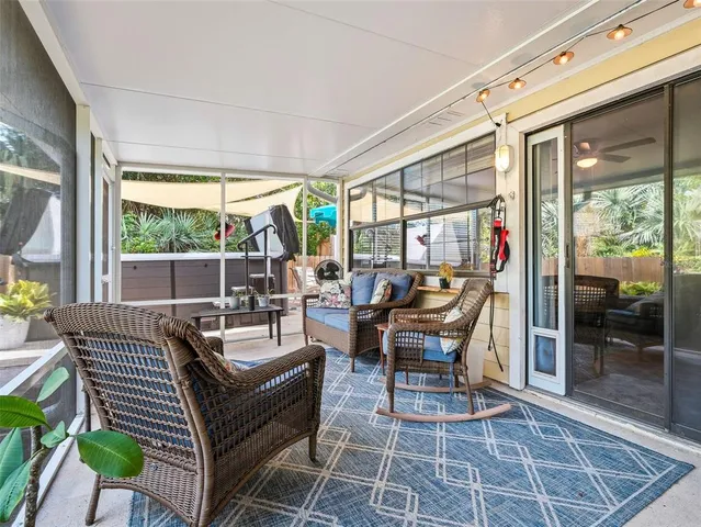 a living room with furniture and a large window with wooden floor