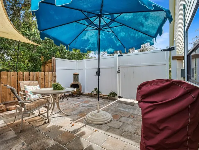 a living room with furniture kitchen view and a chandelier