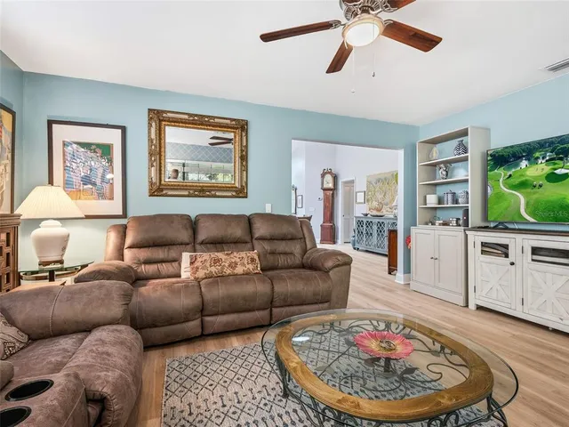 a kitchen with a sink dishwasher stove and white cabinets with wooden floor