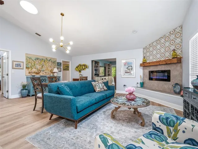 a kitchen with stainless steel appliances white cabinets and wooden floor