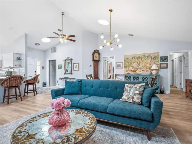a bedroom with a bed and a lamp on dresser