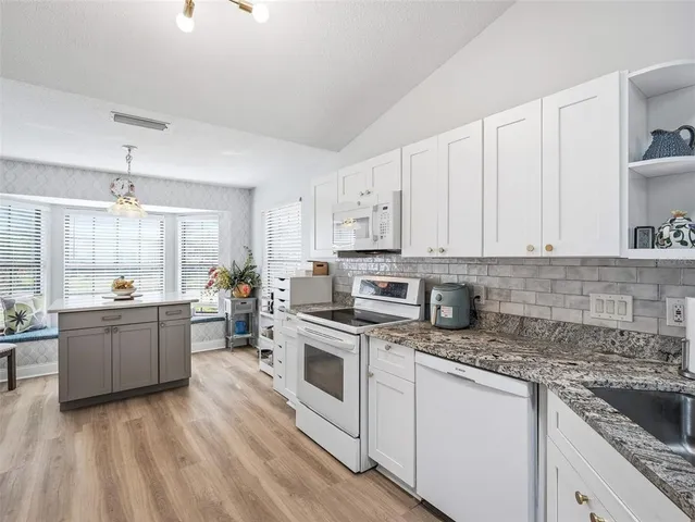 a spacious bathroom with a double vanity sink mirror and bathtub