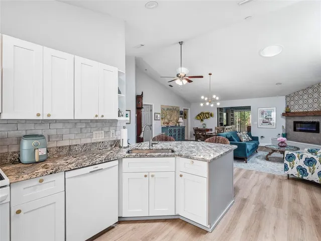 a view of a refrigerator in kitchen and wooden floor
