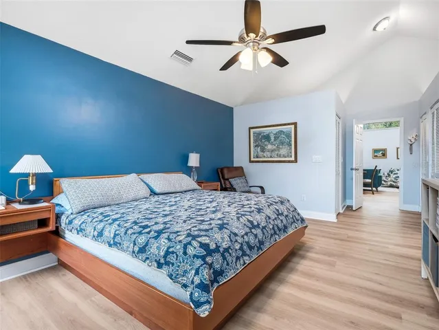 a bedroom with a bed dresser and a flat tv screen