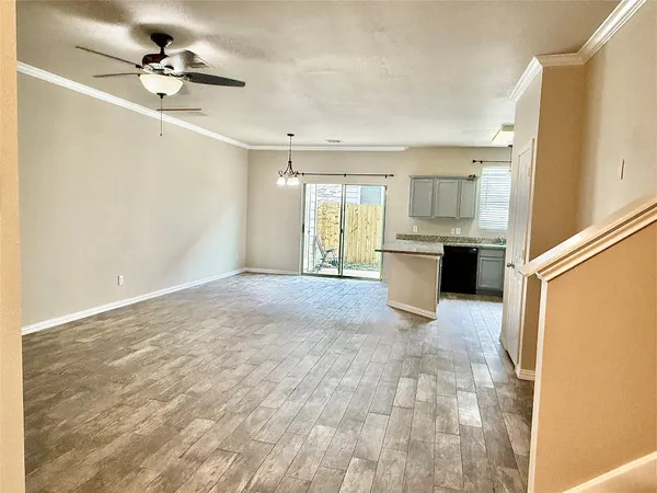 a view of a kitchen with a sink and a refrigerator