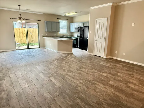 a view of a kitchen with a sink and a refrigerator