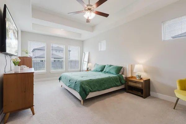 a bedroom with a bed and a chandelier