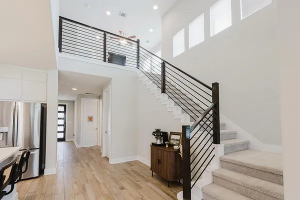a view of entryway and hall with wooden floor