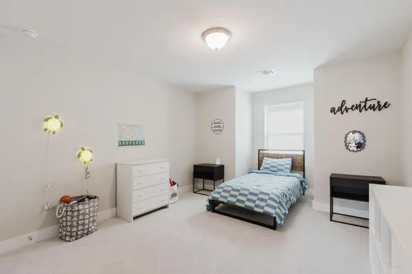 a bedroom with a bed and a table